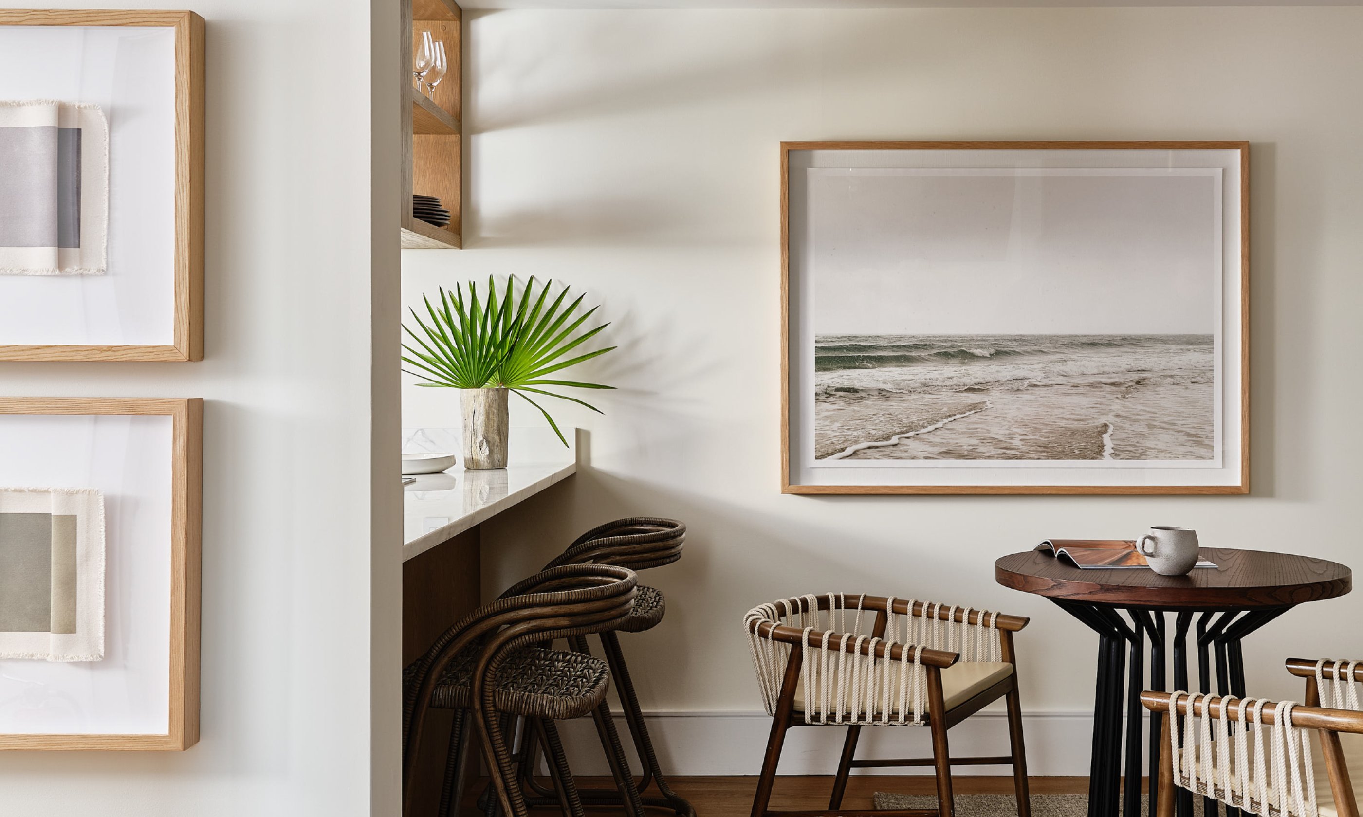 Kitchen seating area with beach themed artwork.